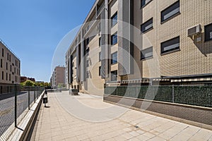 Urbanization facades of residential buildings with common areas with tiles and metal fence