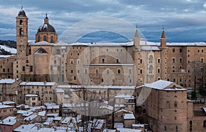 Urbino city during winter storm with snow