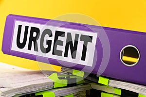 Urgent, Situation Needed, Imperative Important concept. purple folder with the words URGENT photo