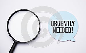 urgently needed speech bubble and black magnifier isolated on the yellow background