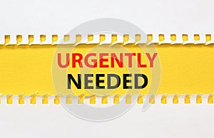 Urgently needed symbol. Concept words Urgently needed on yellow paper on a beautiful white background. Business and urgently