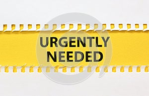 Urgently needed symbol. Concept words Urgently needed on yellow paper on a beautiful white background. Business and urgently