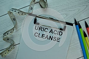 Uric Acid Cleanse write on a paperwork isolated on office desk photo
