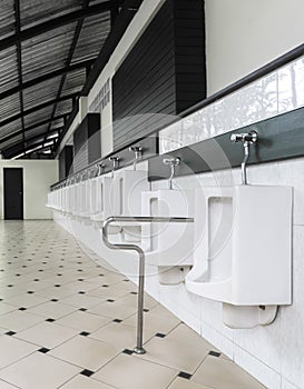 Urinal in a row In the men`s bathroom for disabled people