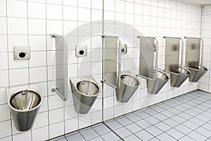 Urinals in men`s public modern toilet restroom sanitary or wc ar
