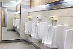 Urinals, toilet, white urinals in men`s bathroom, white ceramic urinals for men in toilet room