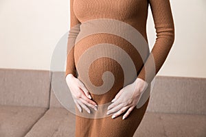 Urinary incontinence during pregnancy. Abdominal pain during pregnancy. Maternity healthcare concept