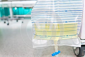 Urine bag hanging beside the patient`s bed.