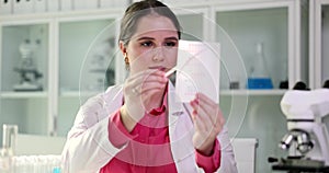 Urine pH test strips and scientist doctor closeup