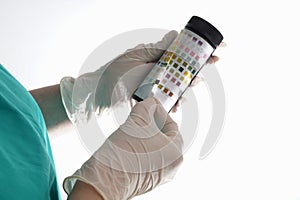 Urine test stripes examined by a nurse