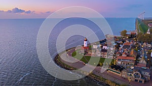 Urk Flevoland Netherlands sunset at the lighthouse and harbor of Urk Holland. Fishing village Urk