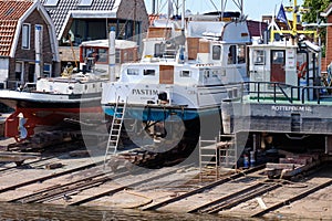 Urk, The Netherlands - June 22 2020: Three yachts for repair and maintenance in the dockyard of Urk, the Netherlands