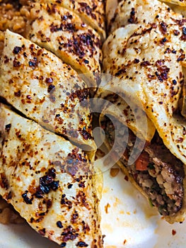 Urkish Beyti Kebab Served with Bulgur Pilaf and Yoghurt.