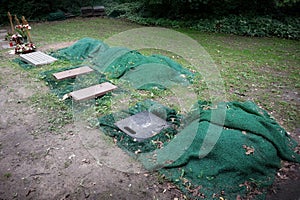 urn graves lined with green mats