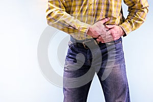 Urolithiasis. Chronic pancreatitis. Stones in the urine. The man grabbed his groin in a fit of pain