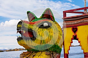 Uros islands typical boat puma head at Titikaka lake, Peru