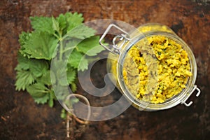 Urtica stinging nettle rice on a grunge background a source for traditional medicine, food, tea, and textile raw material photo