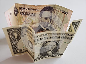 Uruguayan banknote of 100 pesos and American one dollar bill