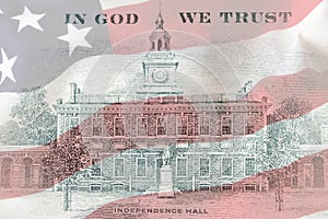 US 100 dollar bill back side close up on american flag background. Hundred dollars bill Independence Hall fragment on macro. Macro