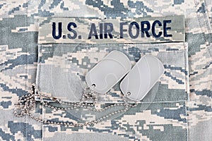 US AIR FORCE branch tape and dog tags on digital tiger-stripe pattern Airman Battle Uniform ABU