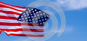 US American flag on blue sky background. For USA Memorial day, Veterans day, Labor day, or 4th of July celebration. Top view, copy