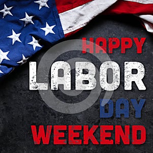 US American flag on dark background. For USA Labor day celebration. With Happy Labor Day Weekend text photo