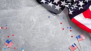 US American flags and confetti star on concrete stone background with copy space. Banner mockup for Presidents day, USA Memorial