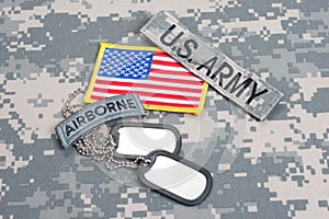 US ARMY airborne tab with blank dog tags on camouflage uniform photo