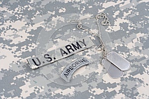 US ARMY airborne tab with dog tags on camouflage uniform