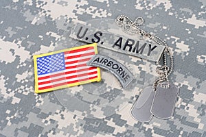US ARMY airborne tab, flag patch, with dog tags on camouflage uniform