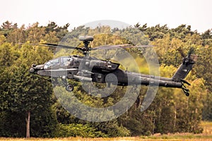 US Army Boeing AH-64D Apache attack helicopter in flight. Brabant, The Netherlands - July 3, 2020 photo