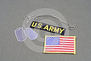 US ARMY Branch Of Service Tape with dog tags and flag patch on olive green uniform