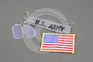 US ARMY Branch Of Service Tape with dog tags and flag patch on olive green uniform