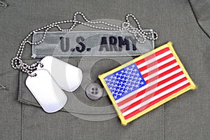 US ARMY Branch Of Service Tape with dog tags and flag patch on olive green uniform