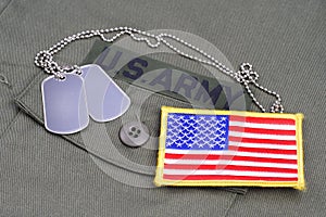 US ARMY Branch Of Service Tape with dog tags and flag patch on olive green uniform