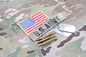 US ARMY branch tape with dog tag flag patch and 5.56 mm rounds on uniform