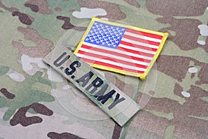 US ARMY branch tape with flag patch on camouflage uniform