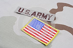 US ARMY branch tape and US flag patch on desert camouflage uniform