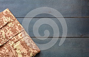 US army camouflage uniform on blue background, top view