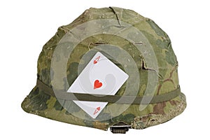 US Army helmet Vietnam war period with camouflage cover and ammo belt and amulet - ace of hearts playing card