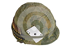 US Army helmet Vietnam war period with camouflage cover and ammo belt and amulet the ace of spades playing card