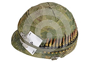 US Army helmet Vietnam war period with camouflage cover and ammo belt, dog tag and amulet ace of clubs playing card