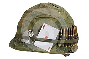 US Army helmet Vietnam war period with camouflage cover and ammo belt, dog tag and amulet playing card ace of diamonds