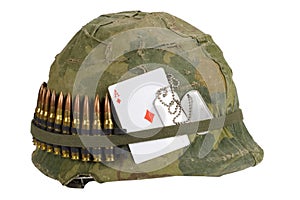 US Army helmet Vietnam war period with camouflage cover and ammo belt, dog tag and amulet playing card ace of diamonds