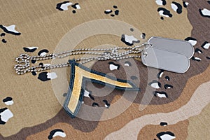 US ARMY Private rank patch and dog tags on desert camouflage uniform