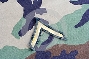 US ARMY Private rank patch on woodland camouflage uniform