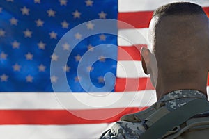 US Army Soldier Looking At Flag