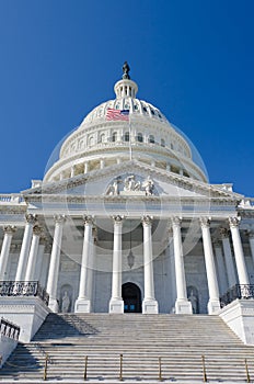 US Capitol building Entrance with US flag waves