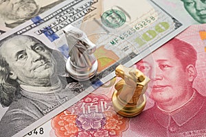 The US and China trade war and currency war concept. Two knights chess face to face competition on US dollar and Chinese yuan