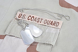 US COAST GUARD branch tape with dog tags on desert camouflage uniform
